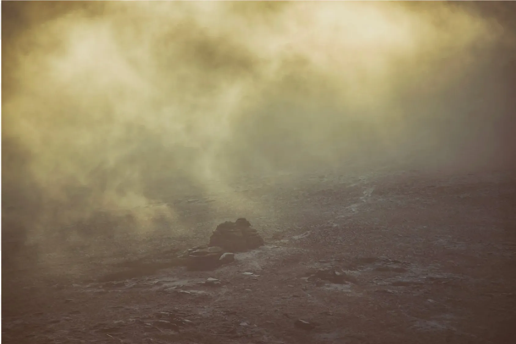 Mist rolling over a granite cairn on Dartmoor